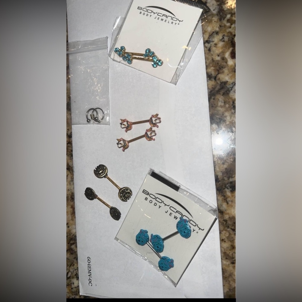 Assorted body jewelry. Nipple and nose